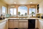 Watch the boats on the bay and the ocean beyond in this beautiful kitchen